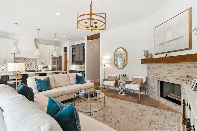 living room featuring a fireplace, a chandelier, dark hardwood / wood-style floors, and ornamental molding