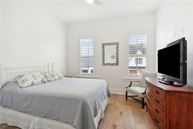 bedroom with light wood-type flooring and multiple windows