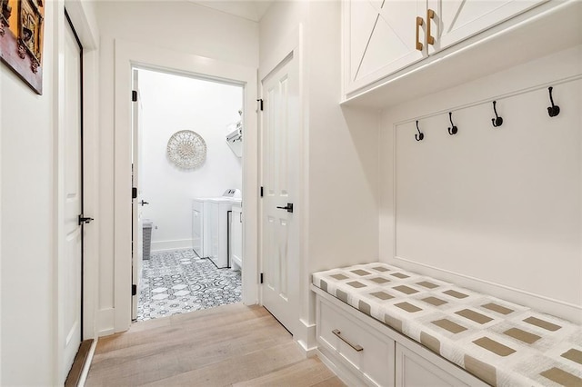 mudroom featuring washer and clothes dryer and light wood-type flooring