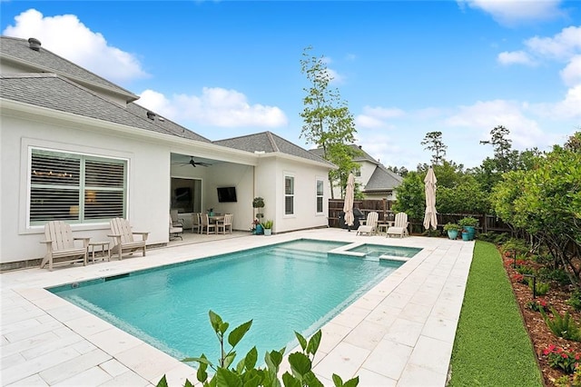 view of swimming pool with ceiling fan and a patio