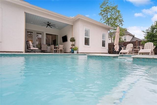 view of swimming pool featuring ceiling fan