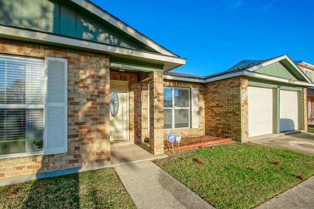 property entrance with a garage and a yard