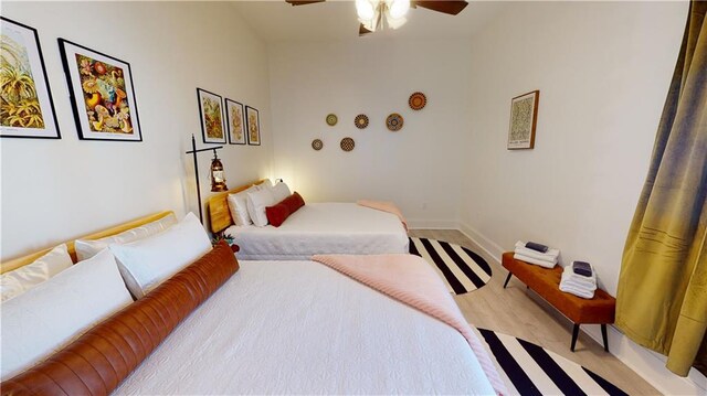 bedroom with ceiling fan and light wood-type flooring