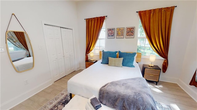 bedroom featuring light hardwood / wood-style floors and a closet