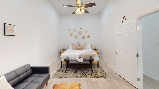 bedroom featuring ceiling fan and light hardwood / wood-style flooring