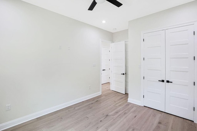 unfurnished bedroom with ceiling fan, light hardwood / wood-style flooring, and a closet