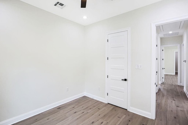 spare room featuring ceiling fan and light hardwood / wood-style flooring