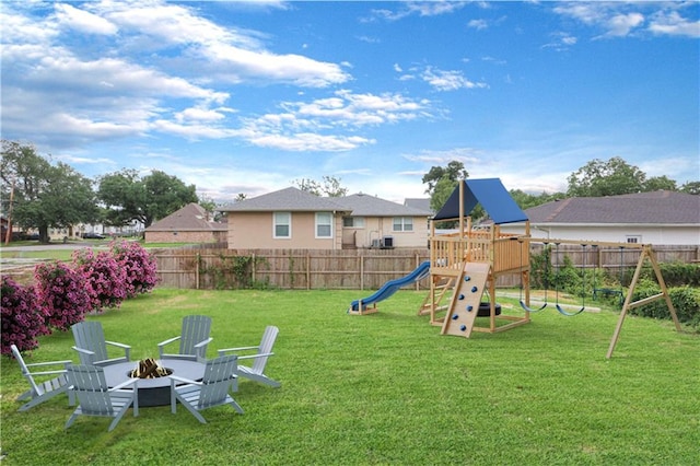 view of playground with a yard and an outdoor fire pit