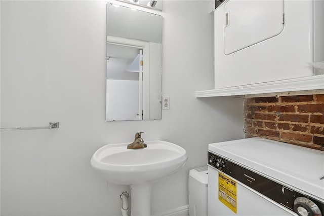 bathroom featuring brick wall