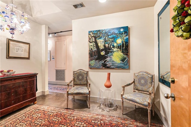 living area with an inviting chandelier