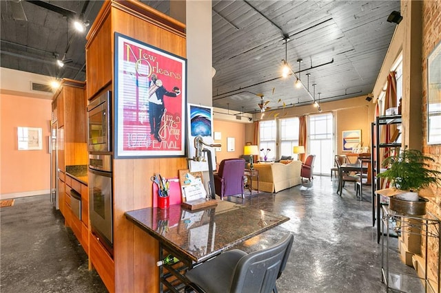 interior space featuring wood walls and rail lighting