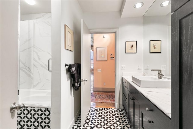 bathroom with a shower with door and vanity