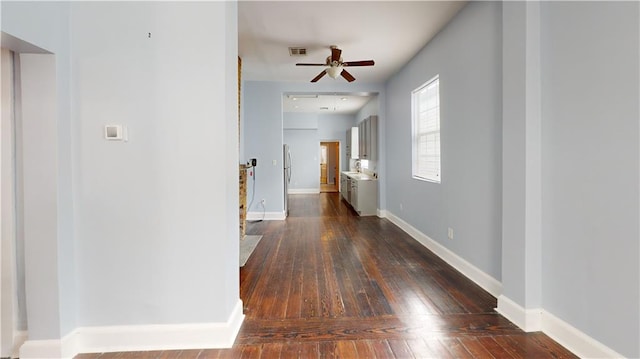 corridor with dark hardwood / wood-style flooring