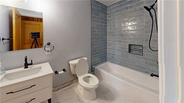 full bathroom with tiled shower / bath, vanity, toilet, and tile patterned floors