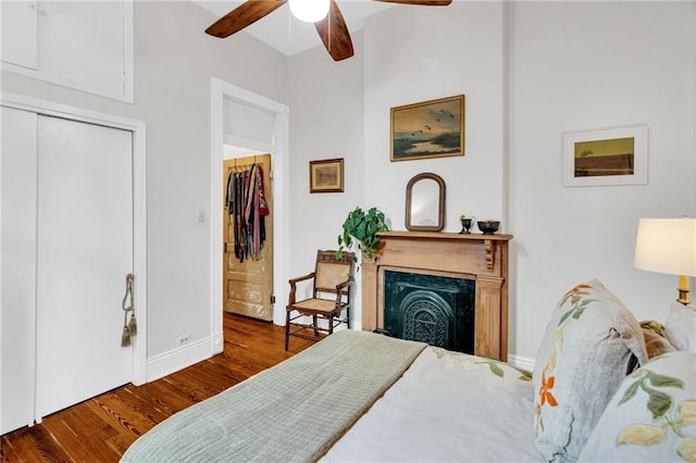 bedroom featuring hardwood / wood-style flooring, ceiling fan, and a closet