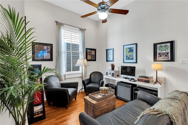 living room with ceiling fan and light wood-type flooring