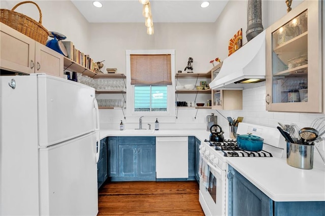 kitchen featuring white appliances, blue cabinets, sink, tasteful backsplash, and dark hardwood / wood-style flooring