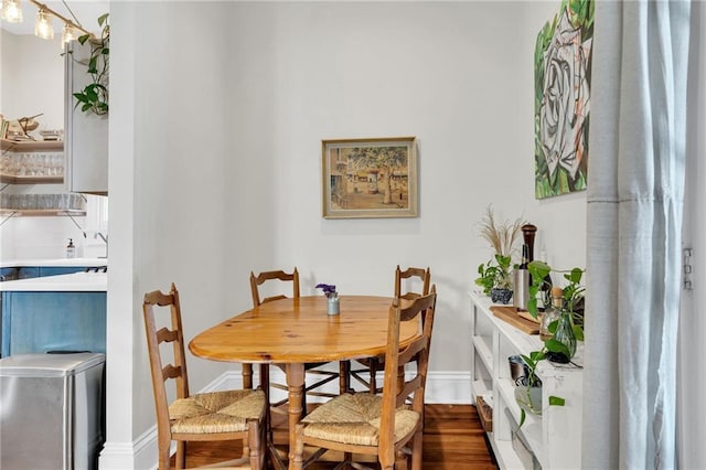 dining space with dark hardwood / wood-style floors