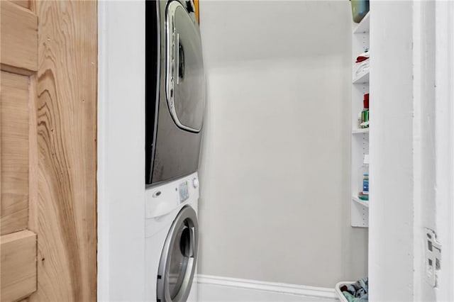 washroom featuring stacked washing maching and dryer