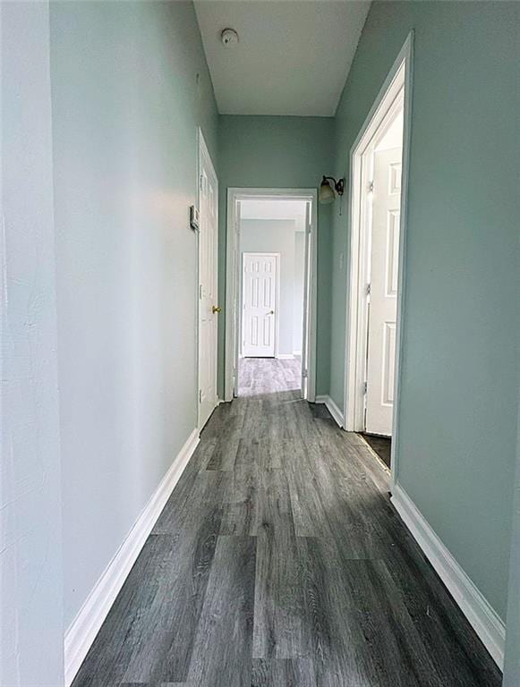 corridor with dark hardwood / wood-style floors