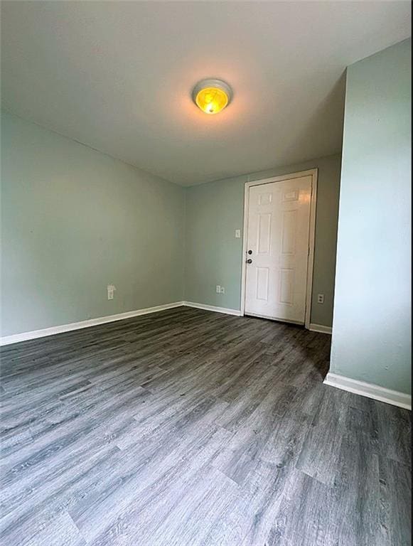 unfurnished room featuring dark hardwood / wood-style floors