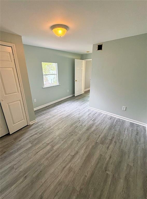 spare room with dark hardwood / wood-style flooring