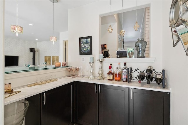 bar featuring a bar and decorative light fixtures