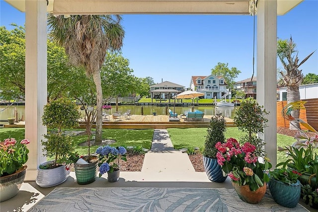 view of patio / terrace with a deck with water view and fence