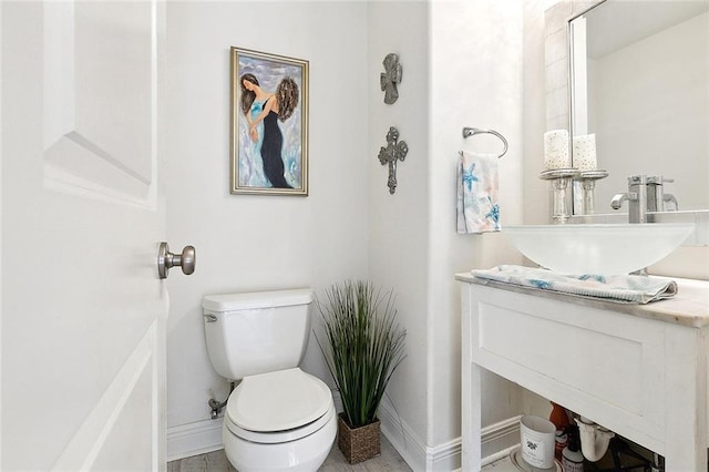 4610 Alba Rd, New Orleans, LA 70129 - bathroom with toilet, vanity, and baseboards