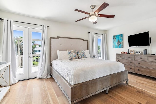 bedroom featuring light wood-type flooring, access to outside, a ceiling fan, and french doors