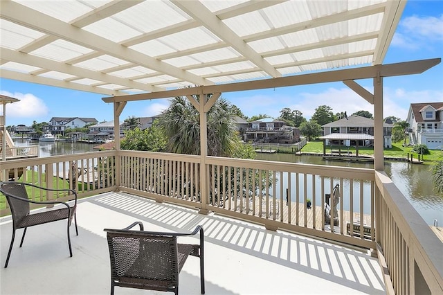 deck with a water view, a residential view, a pergola, and a patio