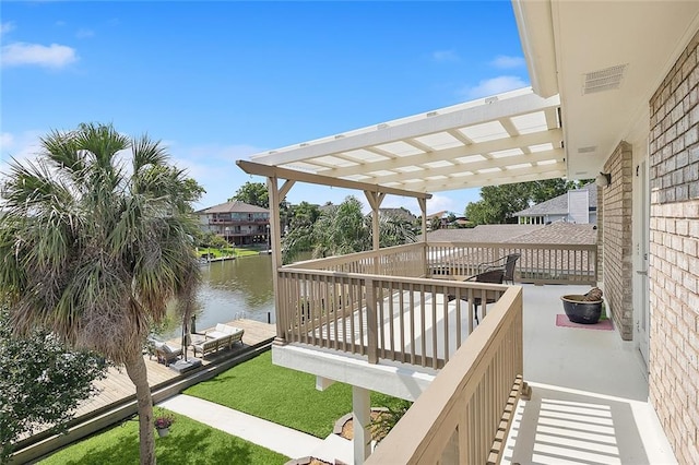 deck with a water view and a pergola