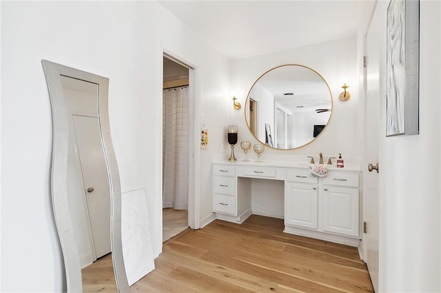 full bath with wood finished floors and vanity