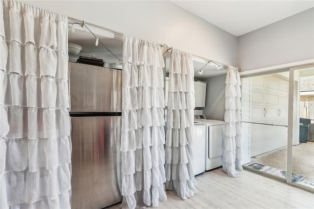 bathroom featuring wood finished floors and independent washer and dryer