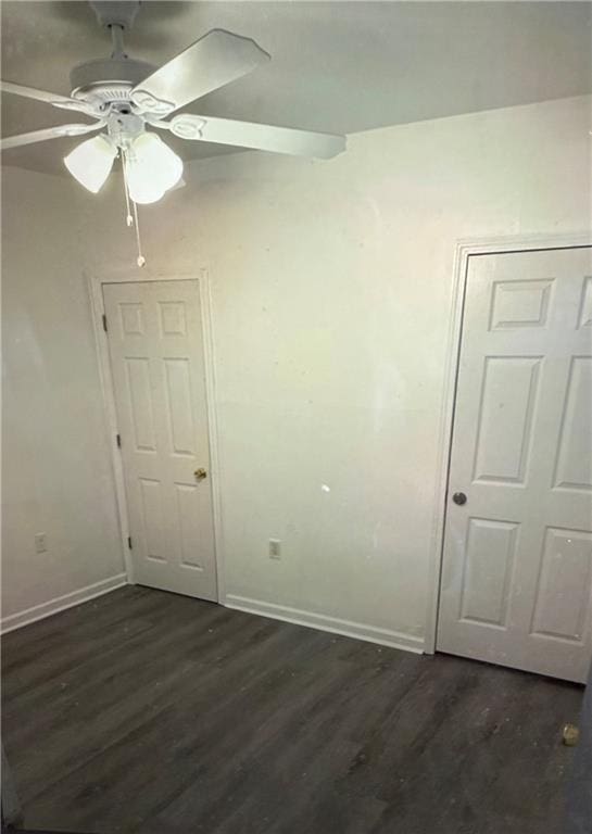 empty room featuring dark hardwood / wood-style floors and ceiling fan