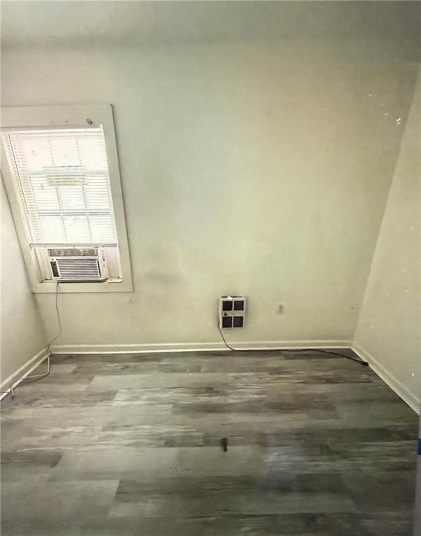 clothes washing area featuring dark hardwood / wood-style floors and cooling unit