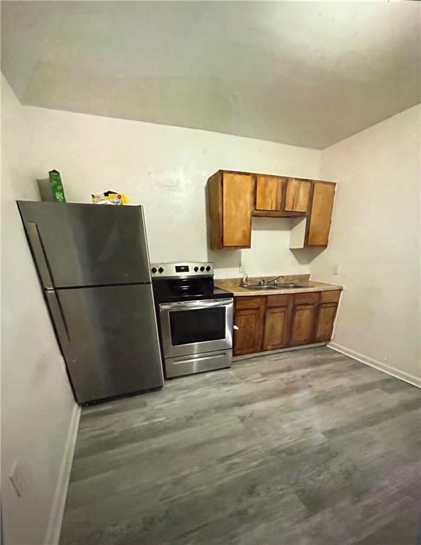 kitchen featuring sink, hardwood / wood-style floors, and appliances with stainless steel finishes