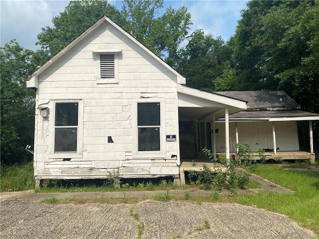 rear view of house featuring a porch