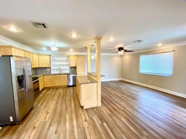 kitchen featuring light brown cabinets, ornamental molding, tasteful backsplash, light hardwood / wood-style floors, and stainless steel appliances