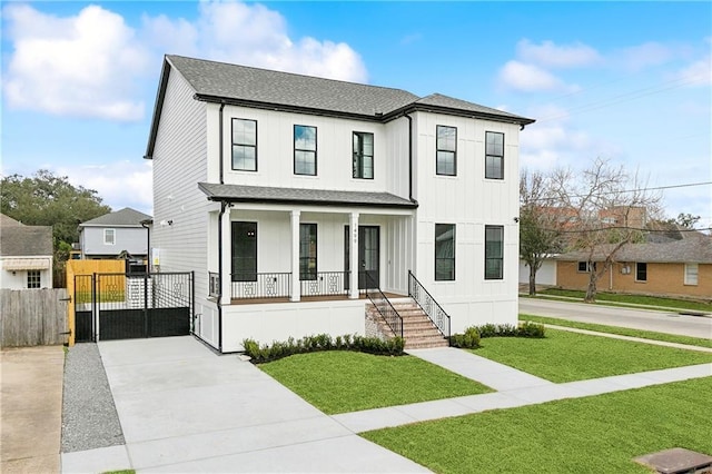 view of front of house with covered porch and a front yard