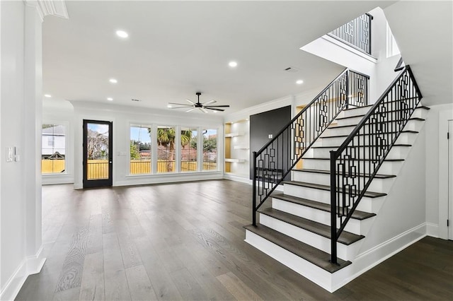 staircase with hardwood / wood-style flooring, ceiling fan, and ornamental molding