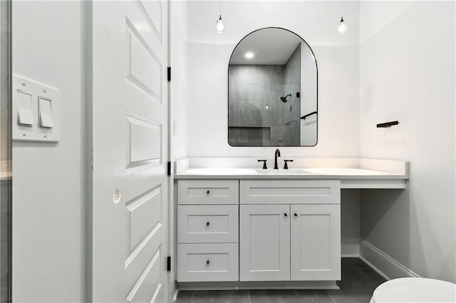 bathroom with tile patterned floors, vanity, and walk in shower