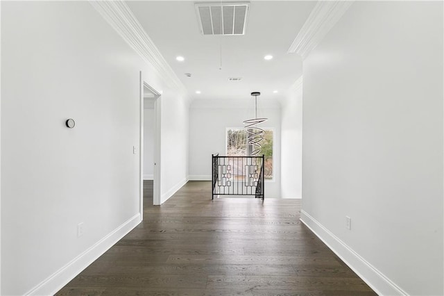 hall with dark hardwood / wood-style floors and ornamental molding