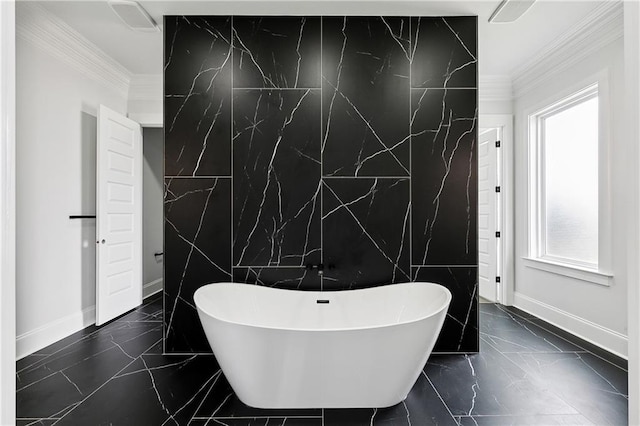 bathroom with a healthy amount of sunlight, crown molding, and a tub