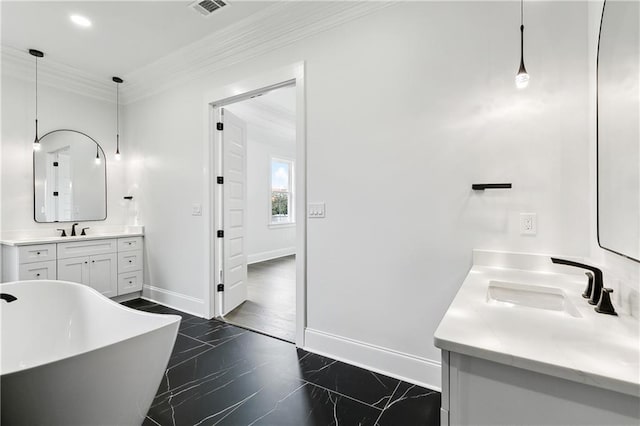 bathroom featuring ornamental molding, vanity, and a bathing tub