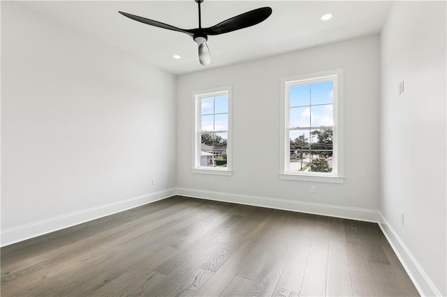 unfurnished room with ceiling fan and dark hardwood / wood-style flooring