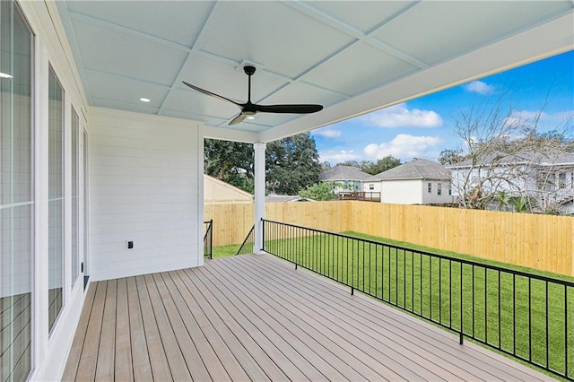 deck featuring ceiling fan and a yard