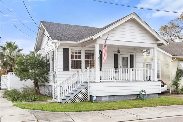 bungalow-style house featuring a front lawn and a porch