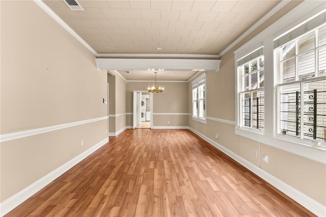 unfurnished room featuring ornamental molding, light hardwood / wood-style floors, and a notable chandelier