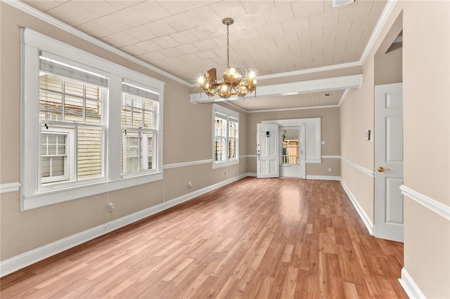 unfurnished dining area with a chandelier, crown molding, and light hardwood / wood-style flooring